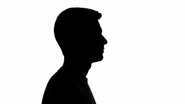 A solid black profile silhouette of a man on a near-white background